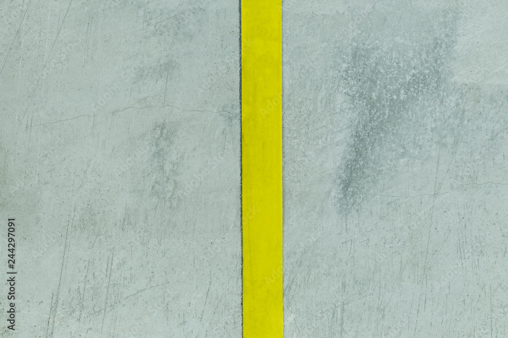 Fototapeta premium concrete wall. filmed in dark weather. it has a strip of yellow color. divided into two parts