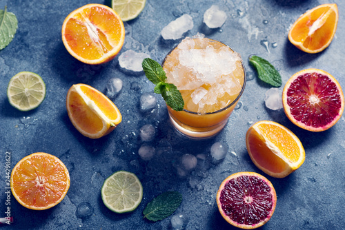 Fototapeta Naklejka Na Ścianę i Meble -  Orange juice or lemonade with crashed ice, healthy vitamin c drink, blood oranges