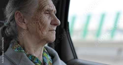 Close-up face of an old woman with wrinkles.