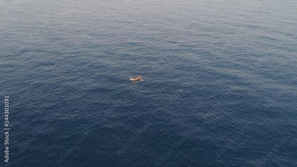 small fishing boat in sea. aerial view indonesian fishermen on boat in ocean bali, indonesia small fishing boat in sea. aerial view indonesian fishermen on boat in ocean bali, indonesia