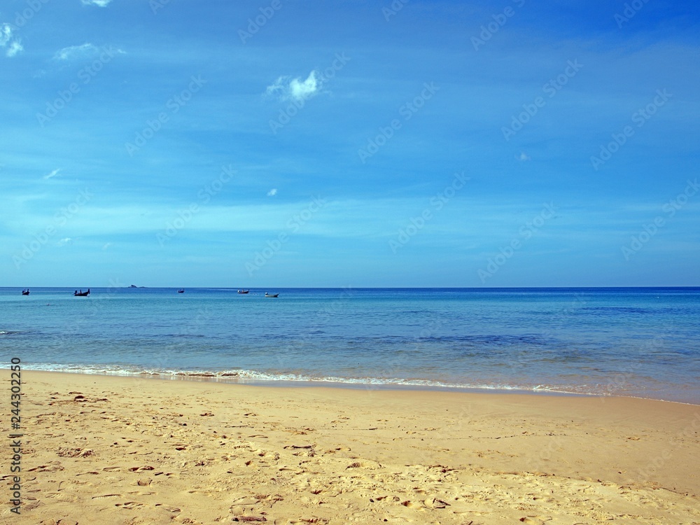 Yellow sand and bright blue sea. Stunning panoramic views of the horizon and the bright blue sea surface of the water. Seascape. Beautiful sky. Open ocean. 