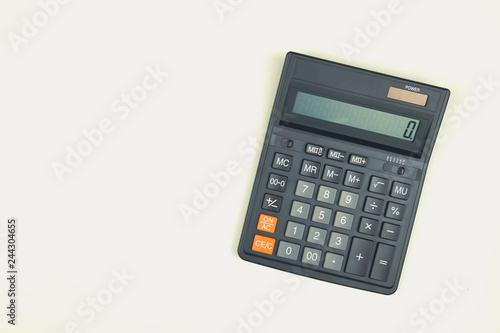 Black big calculator on white background. Toned