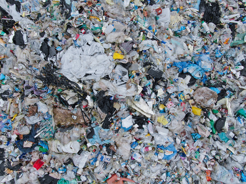 AERIAL: View from above of a stinky heap of garbage in a plastic sorting site