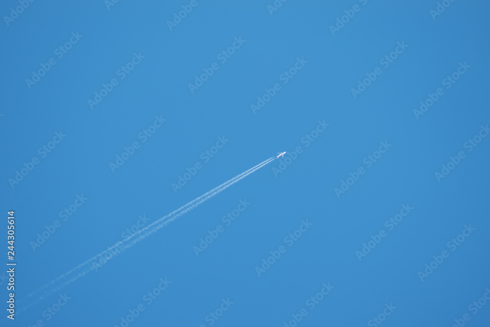 Airplane flying in the blue sky.