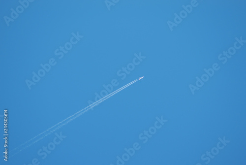 Airplane flying in the blue sky.