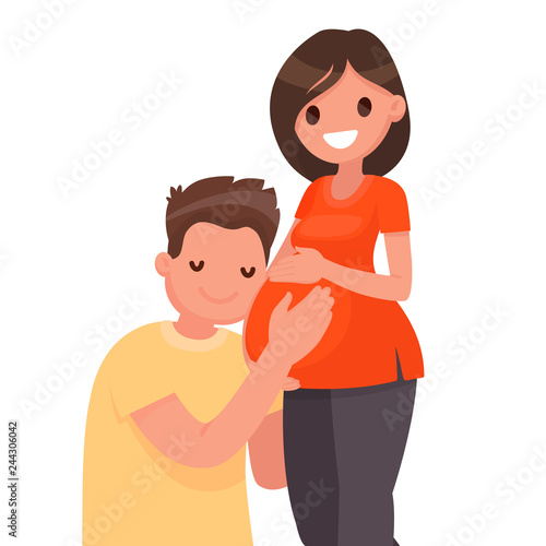 Happy married couple waiting for a child. A man embraces the belly of a pregnant woman. Husband and wife. Pregnancy