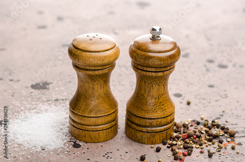 Wooden salt shaker and pepperbox on a light background.