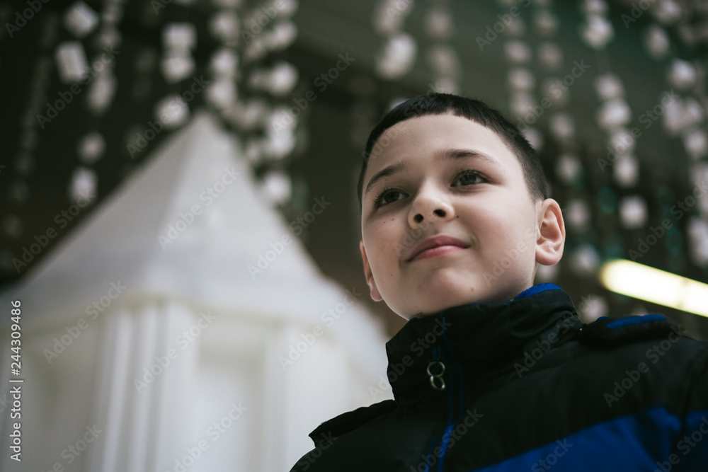 positive schoolboy in the winter decorated mall, close up positive schoolboy in the winter decorated mall, close up