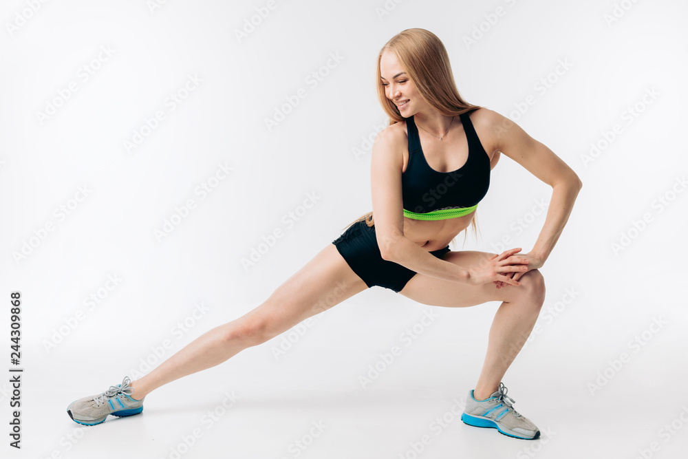 Fitness positive woman stretching legs or doing lunges. full length photo. isolated white background. hobby, free time.