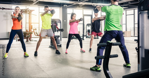 Photos People exercising together with gym equipment