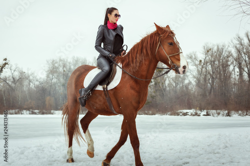 Woman galloping on horseback.