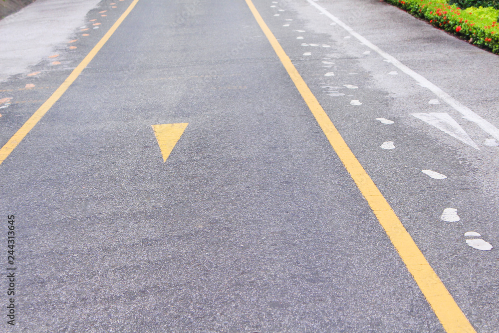 Asphalt road with two yellow lines and sidewalk mark abstract on background Asphalt road with two yellow lines and sidewalk mark abstract on background