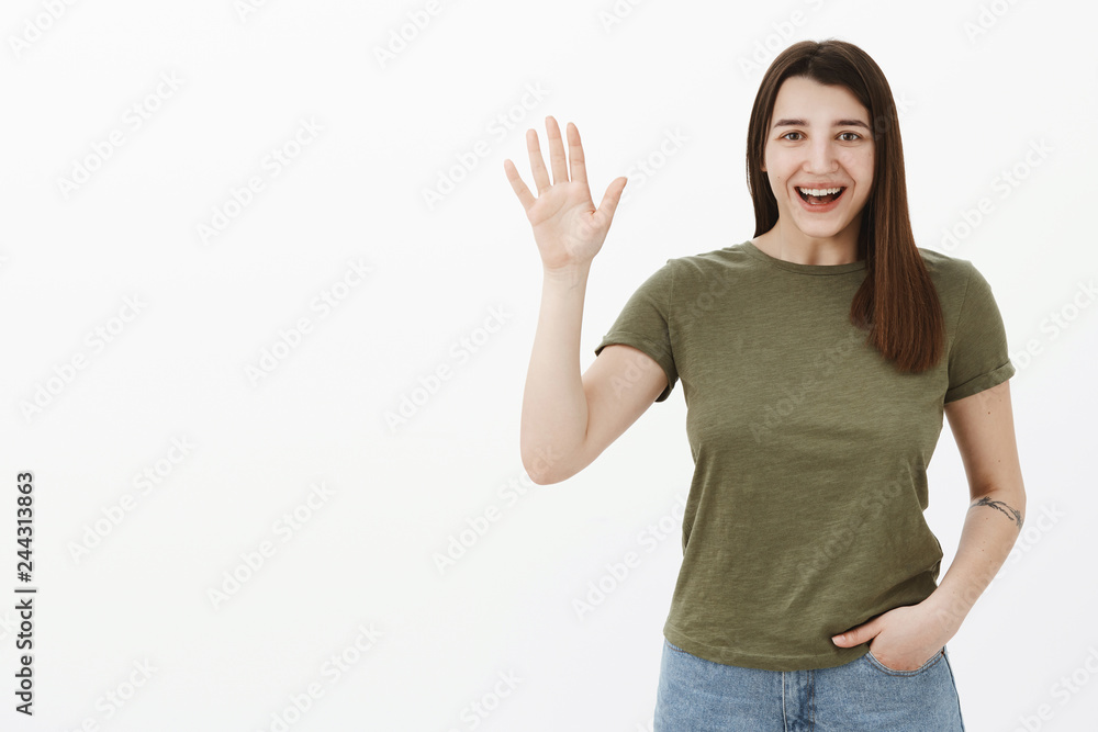 Hey so nice to meet you. Portrait of friendly and excited sincere outgoing woman in t-shirt saying hey as waiving at camera in hello and hi gesture, greeting mates and smiling at camera Hey so nice to meet you. Portrait of friendly and excited sincere outgoing woman in t-shirt saying hey as waiving at camera in hello and hi gesture, greeting mates and smiling at camera