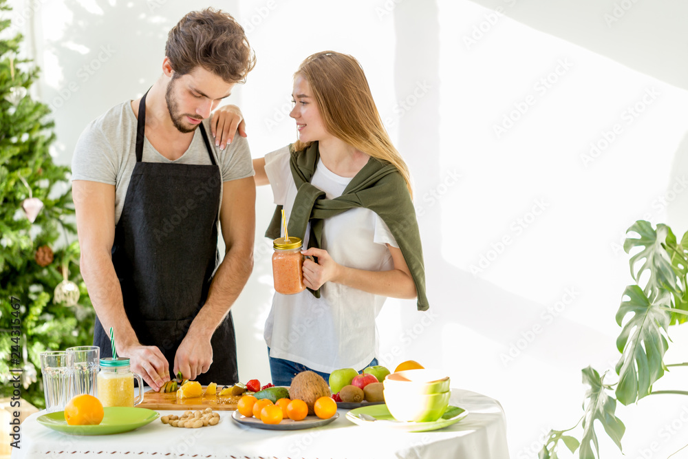 young awesome fair-haired girl is holding a hand on her boyfriend's shoulder and discussing somrthing with him. close up photo. copy space