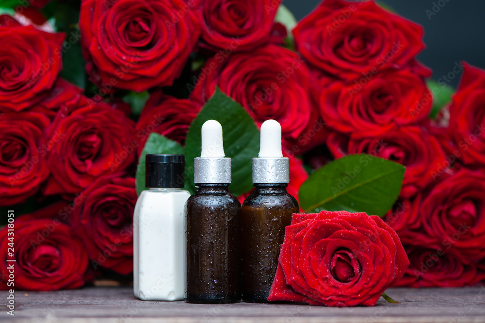Rose Petal oil and cream in bottles and fresh flower and leaves on a natural background, bio, organic , nature cosmetics concept Rose Petal oil and cream in bottles and fresh flower and leaves on a natural background, bio, organic , nature cosmetics concept