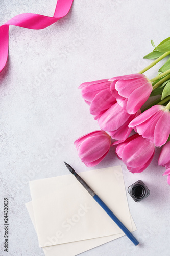 Fototapeta Naklejka Na Ścianę i Meble -  Valentine's Day greeting card with list of paper, tulips and pen