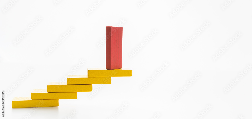 Obraz premium Red wooden block on yellow ones in shape of staircase