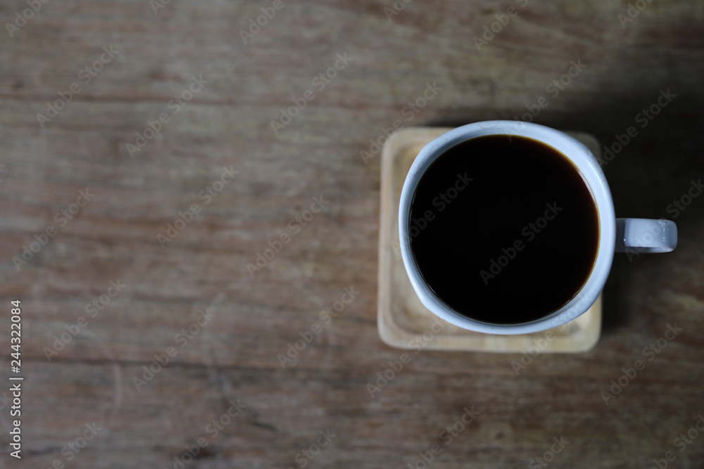 Black coffee in white cup on wooden Black coffee in white cup on wooden