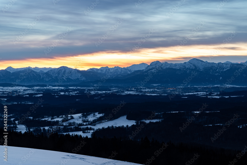 Sunrise at the Hohenpeißenberg, a mountain in Bavaria. A perfect view zo the bavarian alps with red morning glow in the sky.