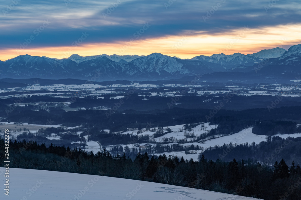 Sunrise at the Hohenpeißenberg, a mountain in Bavaria. A perfect view zo the bavarian alps with red morning glow in the sky.