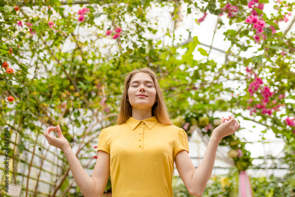 beautiful awesome blond girl doing yoga in the greenhouse healthy lifestyle concept.meditation, concentration.free time beautiful awesome blond girl doing yoga in the greenhouse healthy lifestyle concept.meditation, concentration.free time