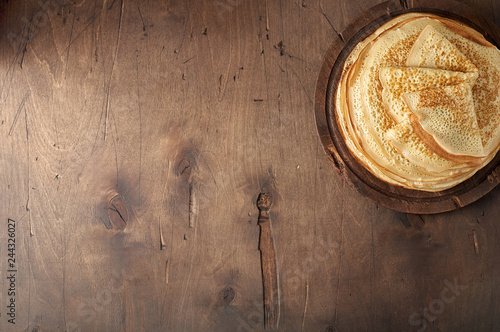 Stack of russian pancake blini on a wooden background