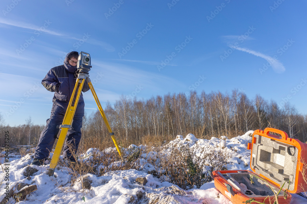 The cadastral service worker conducts surveying and topographic measurements The cadastral service worker conducts surveying and topographic measurements