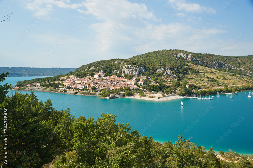 The city on the bank of the artificial lake in France, Provence, lake Saint Cross, gorge Verdone,  azure water of the lake and slopes of mountains on a background, small boats, vacations place