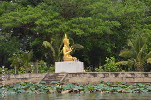 Golden Buddha by the lake. Kanchanaburi  Thailand