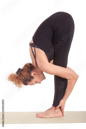 Beautiful Yoga: Woman doing Uttanasana Standing Forward Bend Pose