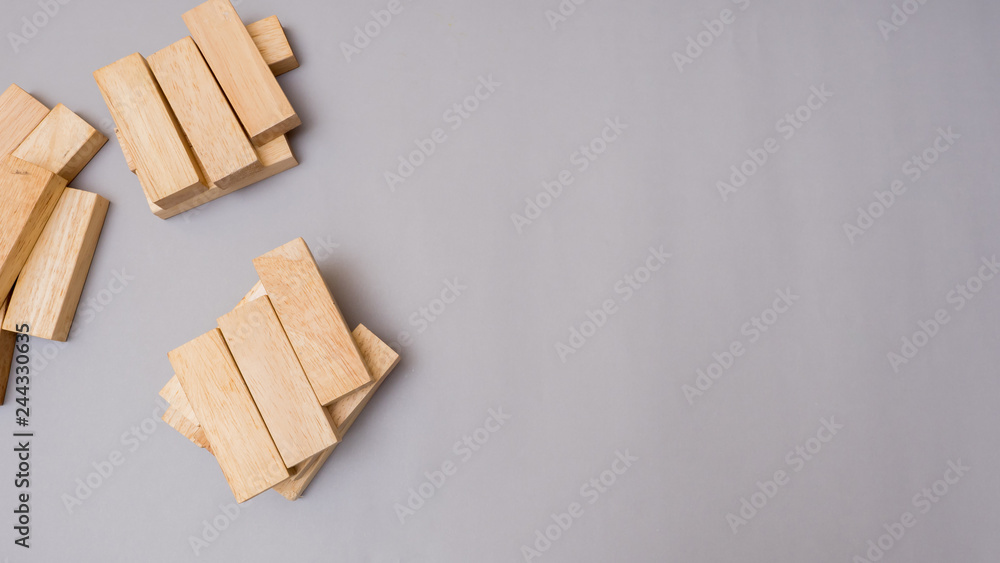 wood block to make structure on gray background,planning in business model ladder success.