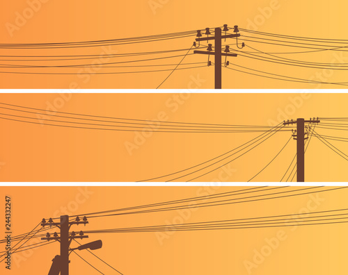 Set of banners of power line poles at sunset.