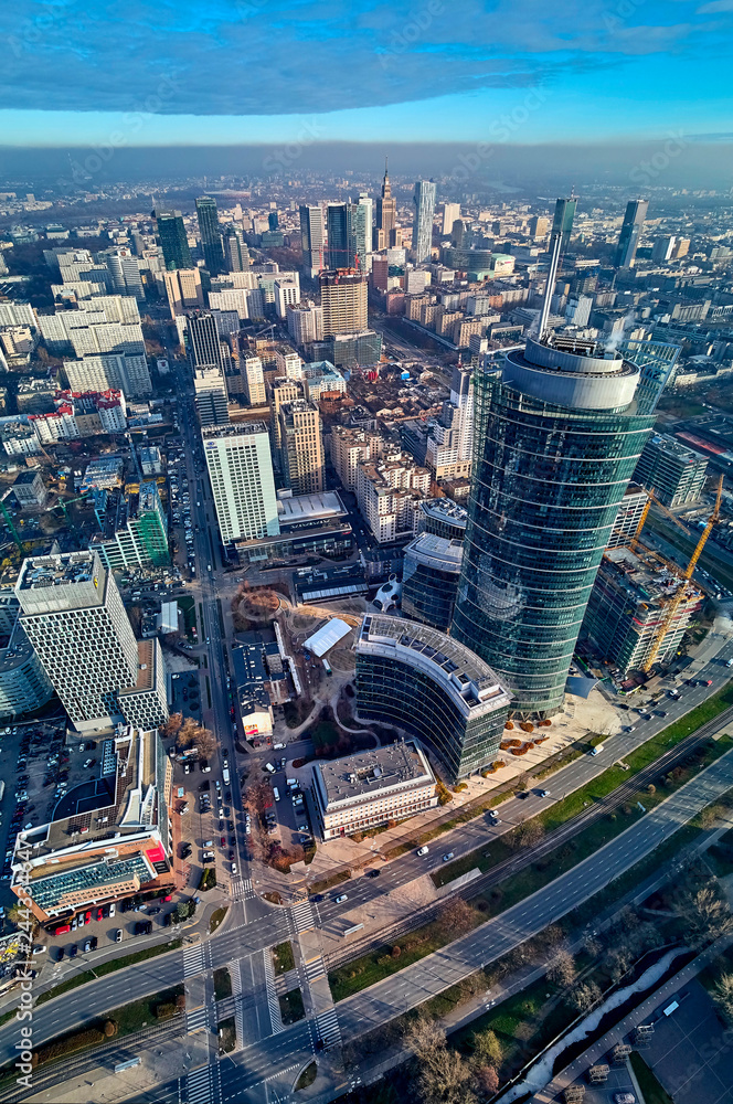 WARSAW, POLAND - NOVEMBER 27, 2018: Beautiful panoramic aerial drone view to the center of Warsaw City and The Warsaw Spire - 220 metre neomodern office building on European square (Plac Europejski)