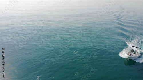 Aerial shot of a bay boat on a quiet sea taken from a drone
