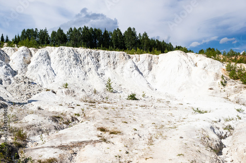 Extraction of talc in career. Abandoned white quarry in forest.