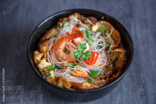 Asian salad with rice noodles with shrimps and vegetables closeup.