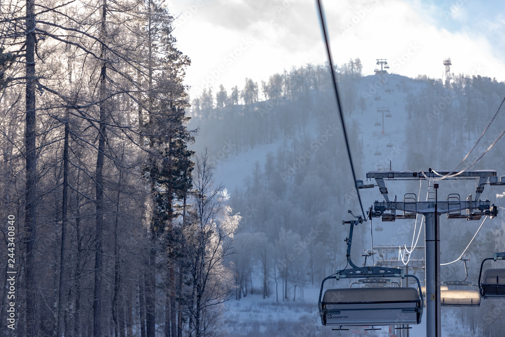 Winter in the mountains. Ski resort. Chair lift. White trees. Snow trees.