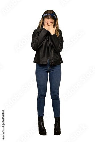 A full-length shot of a Teenager girl with leather jacket with tired and sick expression on isolated white background