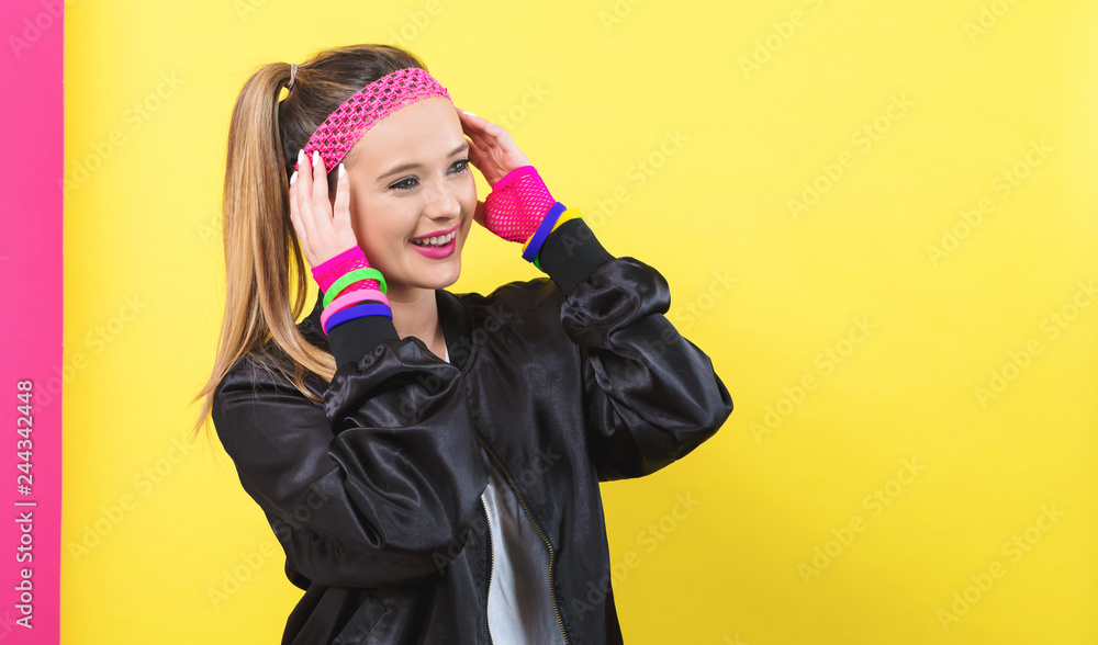 Woman in 1980's fashion theme on a split yellow and pink background Woman in 1980's fashion theme on a split yellow and pink background