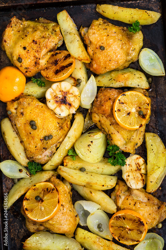 Roasted Chicken with Potatoes and Meyer Lemon. Selective focus.