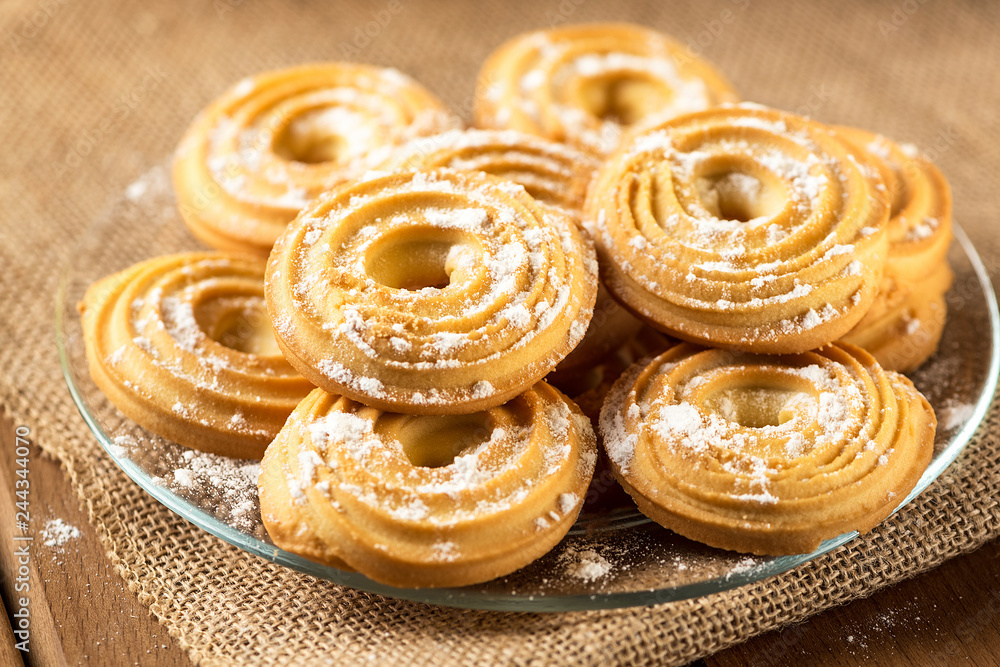 Shortbread biscuits closeup on a plate on a wooden table. Shortbread biscuits closeup on a plate on a wooden table.