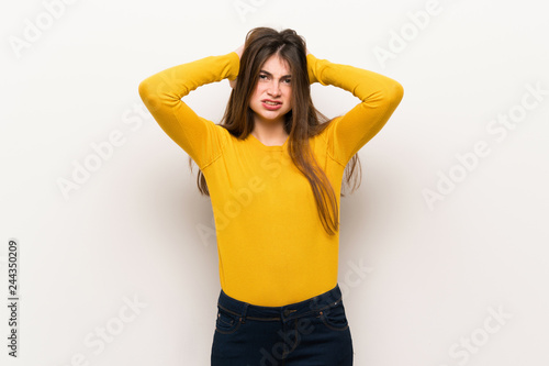 Young woman with yellow sweater takes hands on head because has migraine