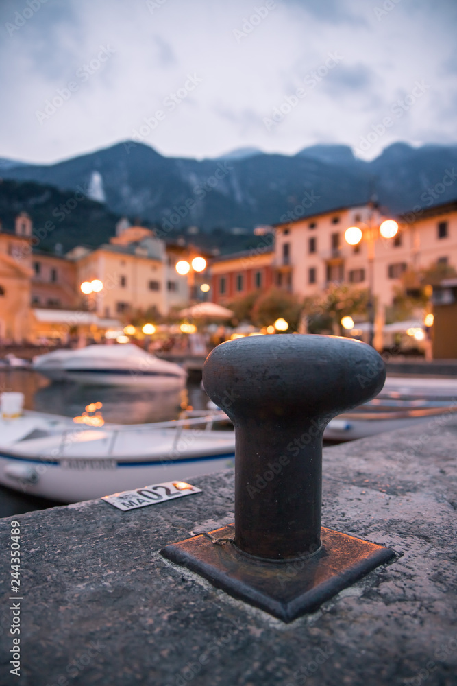 Italian harbour scene on the evening: cute village in the blurry background