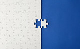 White puzzles on a blue background with one missing piece