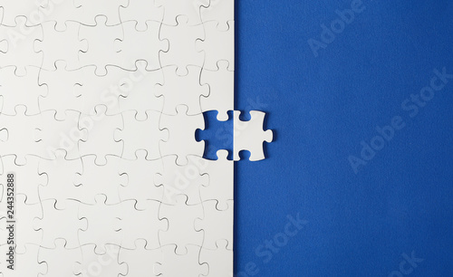 White puzzles on a blue background with one missing piece
