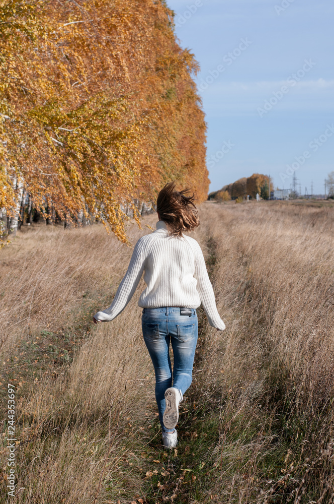 young woman walking in the countryside