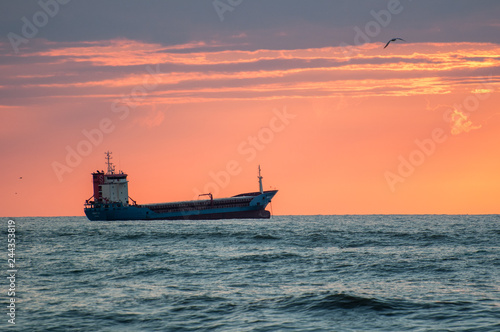 ship in the sea at sunset
