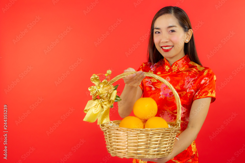 chinese new year beautiful happy smiley asia chiness girl ware Qipao Oriental Chic Cheongsam with red background copy space isolated chinese new year beautiful happy smiley asia chiness girl ware Qipao Oriental Chic Cheongsam with red background copy space isolated