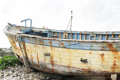 old rusted fishing boats abandoned on the land at the atlantic ocean