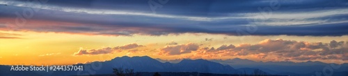 Photography Tranquil panoramia scene of red sun and orange sky sunset over the Rocky Mountains in Colorado by Denver, United States